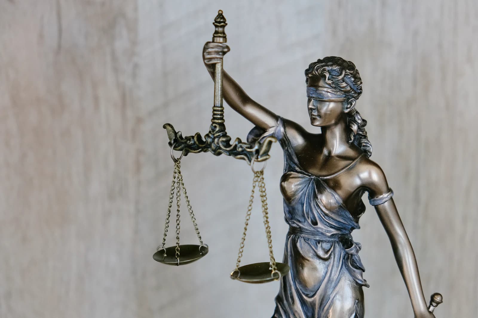 A bronze statue of Lady Justice holding scales