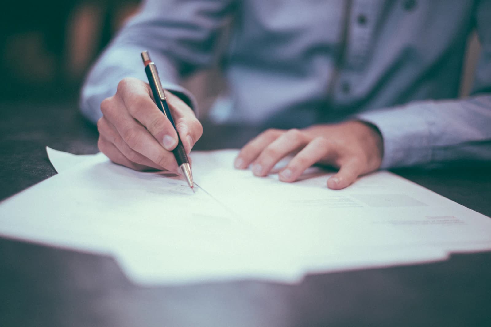 An advocate reviewing case papers at a desk